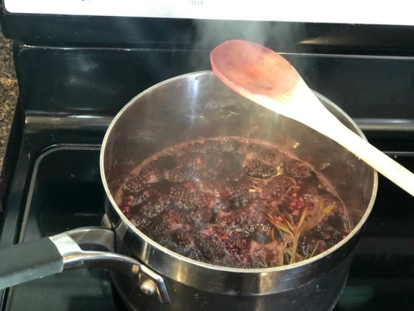 Blackberry sauce in pot simmering