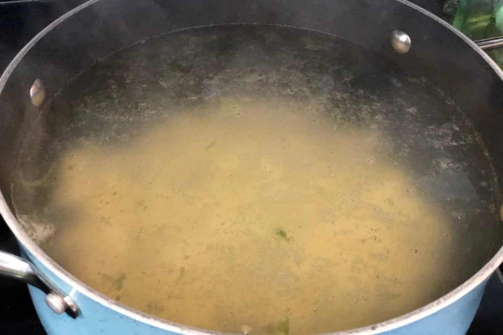 Pot of water with diced potatoes in it starting to boil