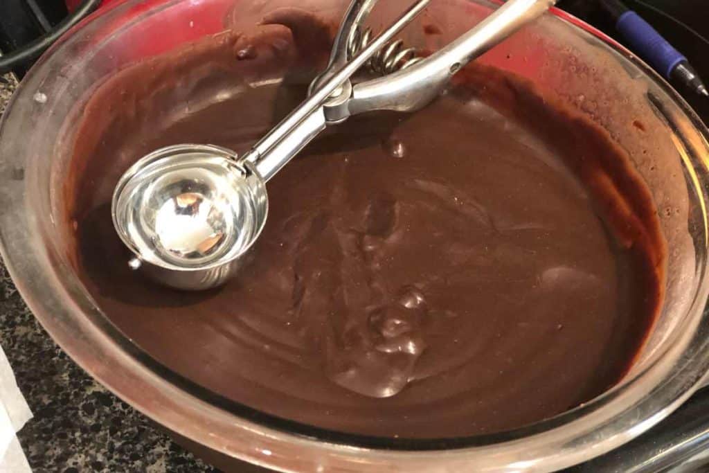 Chilled truffle mix after being in the refrigerator to chill and firm up with a small ice cream scoop.
