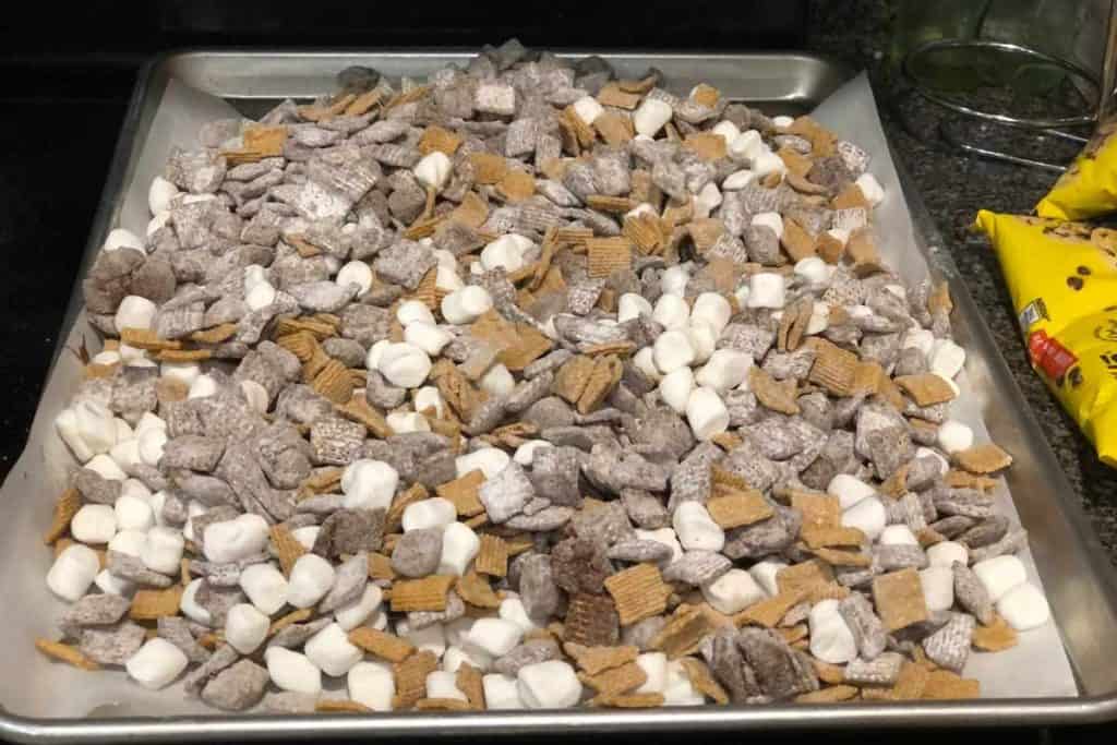 Mixed up Smores Snack Mix on a baking sheet lined with parchment paper