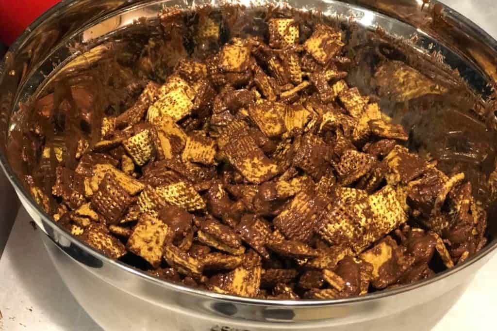 Silver bowl of chocolate covered chex and grahams cereal