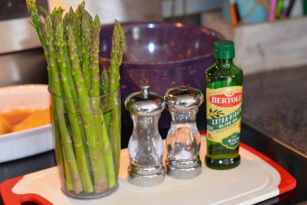 Ingredients for roasted asparagus, including asparagus, extra virgin olive oil, salt and pepper