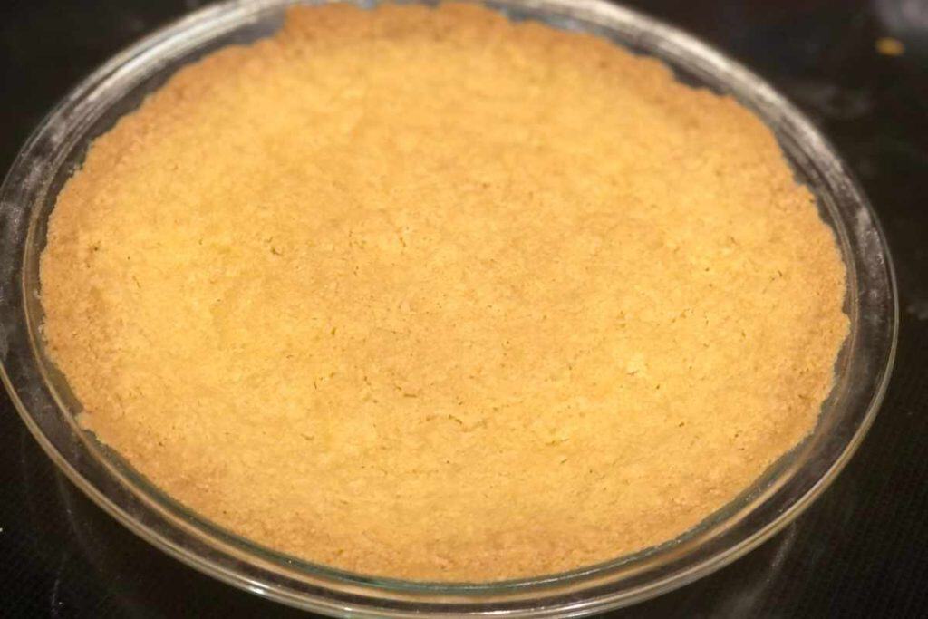 Baked cheesecake crust out of the oven ready to put the filling into the pie crust