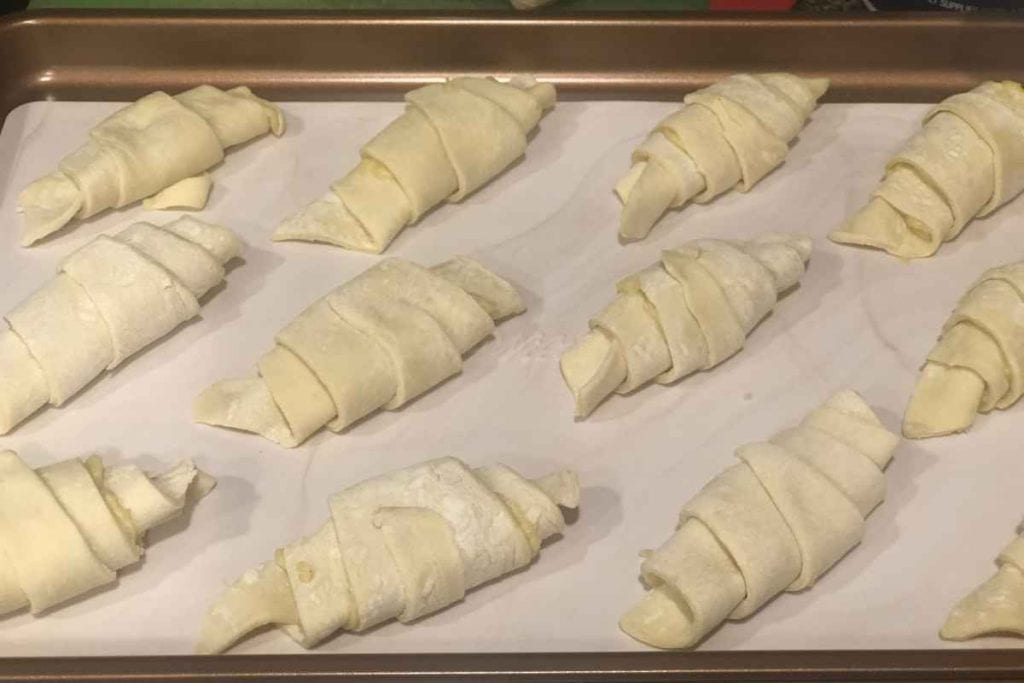Almond croissants rolled and ready to be covered in egg wash