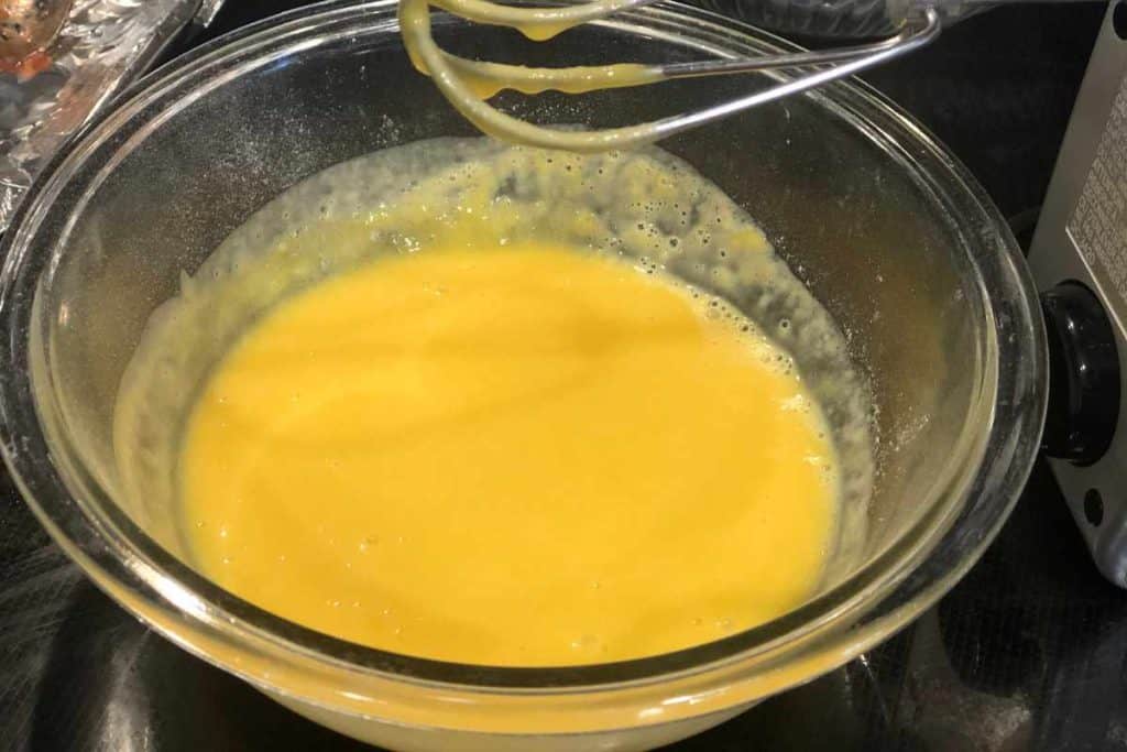 Mixed up evaporated milk and lemon jello combined in a glass bowl