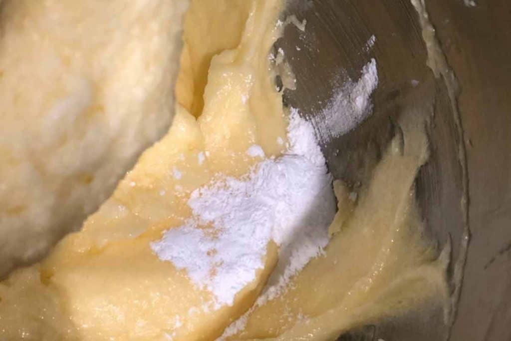 Process shot of lemon pound cake recipe where baking powder has been added to batter