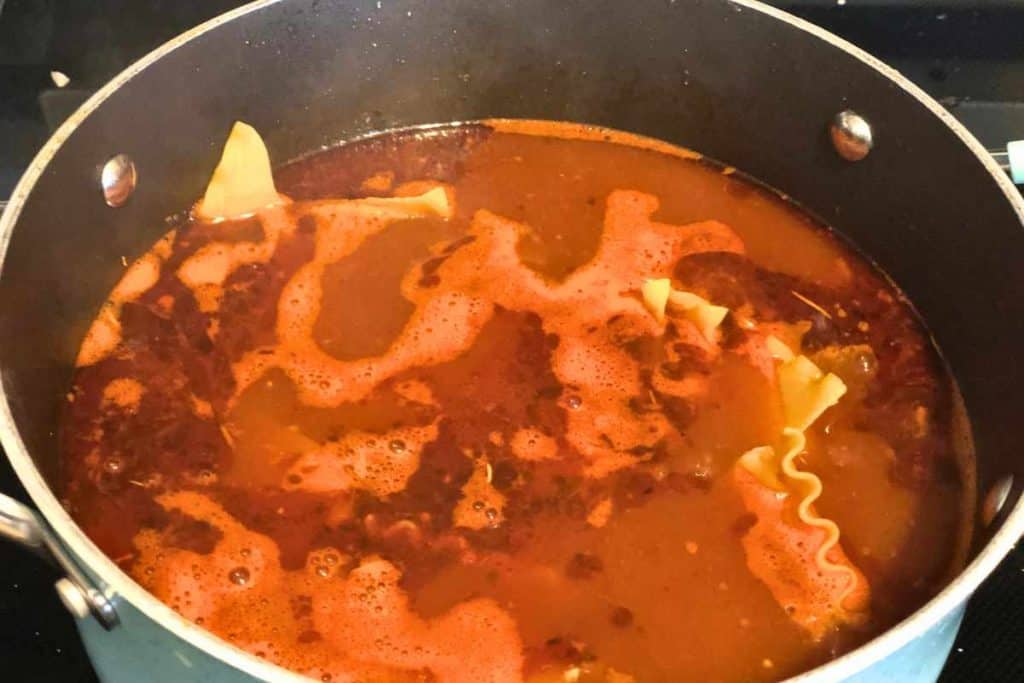 Soup pot with lasagna noodles added into the broth mix