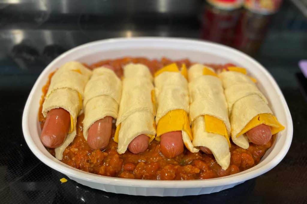 Chili dog casserole with crescent rolls assembled and ready to go into the oven
