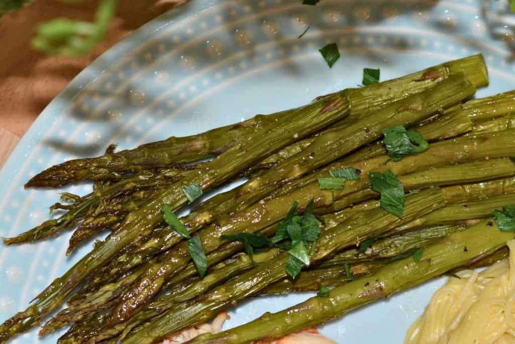 Roasted asparagus on a blue plate