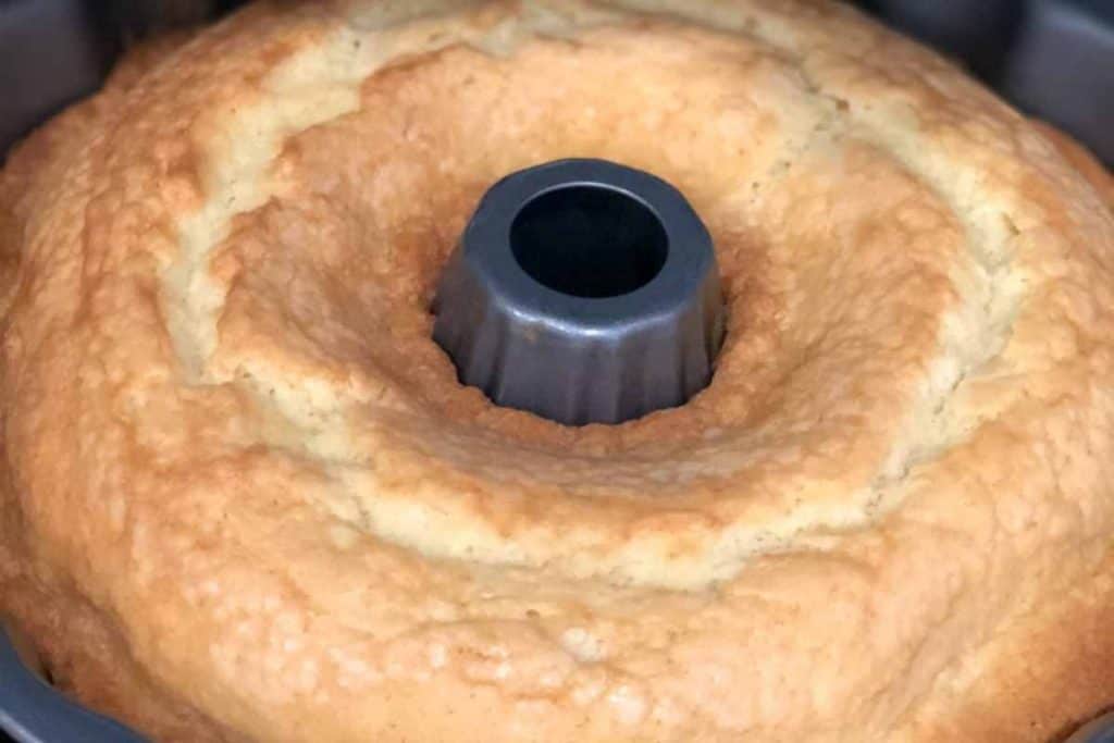 Baked lemon pound cake done in the bundt cake pan, cooling on the counter.