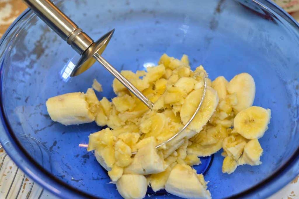 Pastry cutter with halfway mashed bananas for banana bread