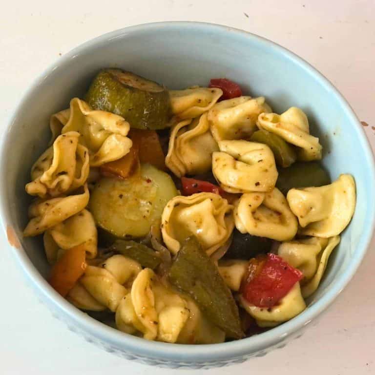 Close up of Cheese tortellini pasta salad in a blue bowl