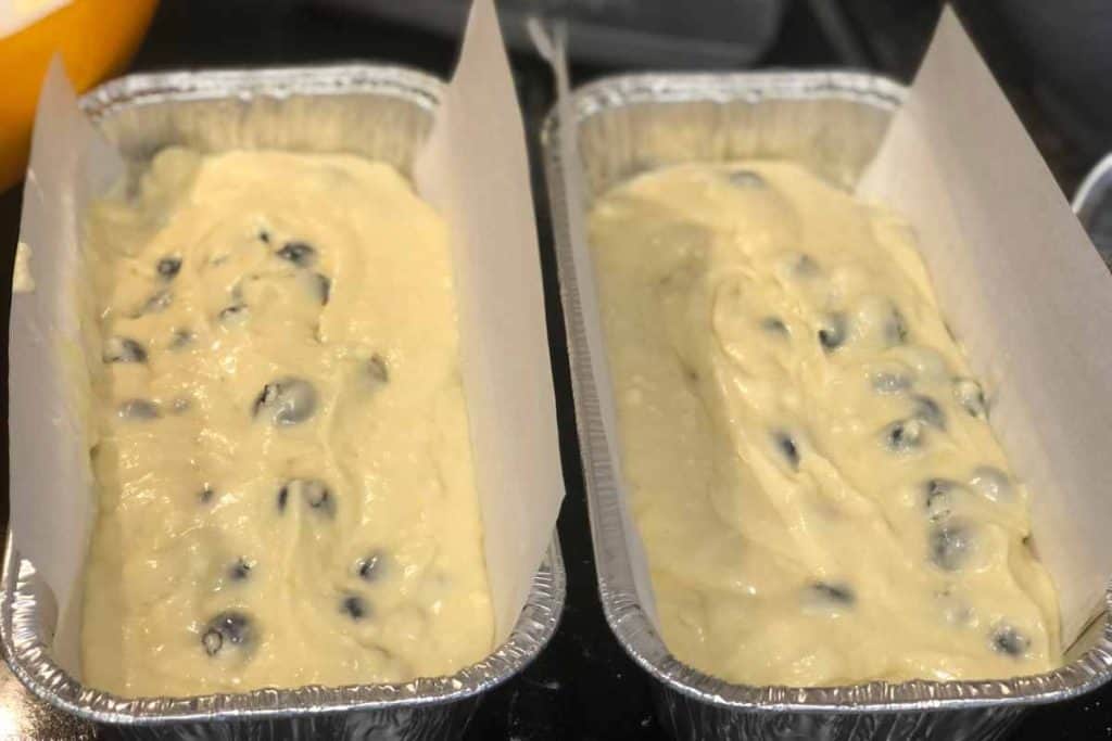 Blueberry Lemon Loaf ready to go into the oven in foil loaf pans lined with parchment paper