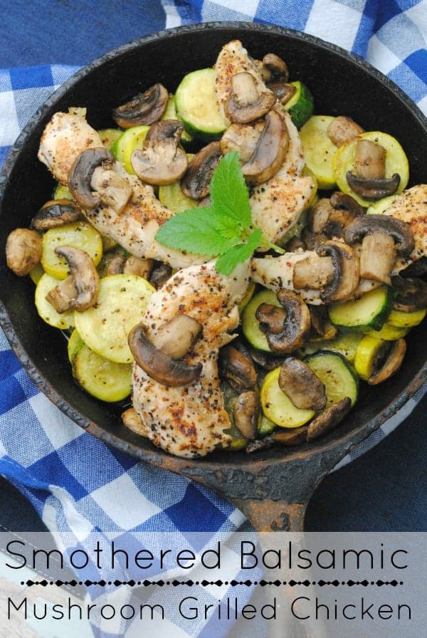 Smothered Balsamic Mushroom Grilled Chicken in a cast iron skillet on a blue and white checkered towel