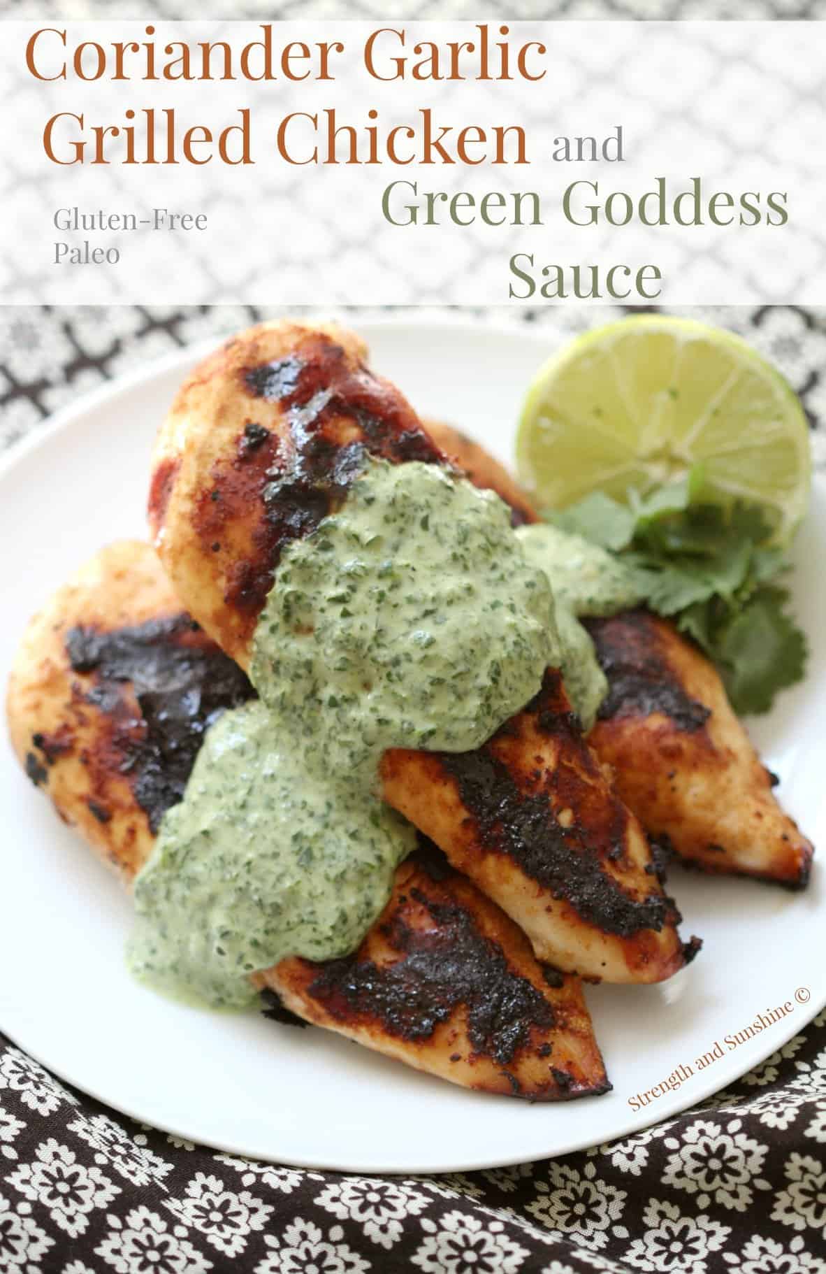 Coriander Garlic Grilled Chicken with a Green Goddess Sauce on a plate with a halved lemon.