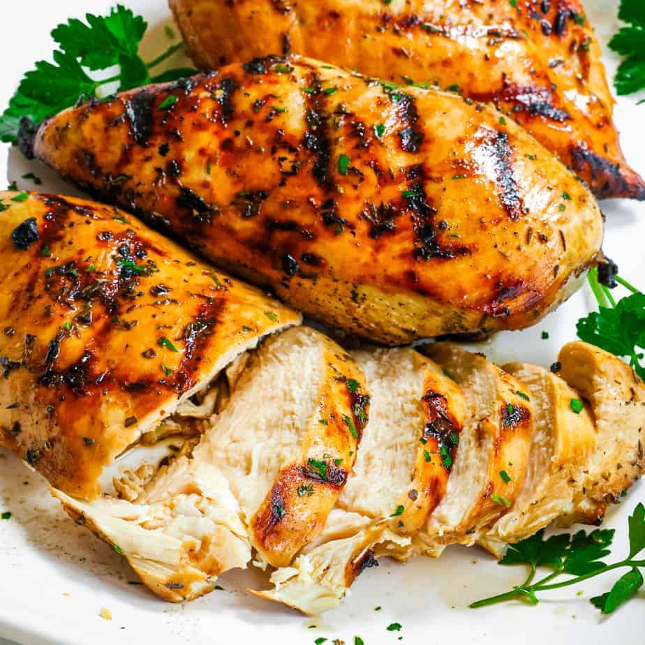 Grilled Chicken on a platter with fresh parsley garnish