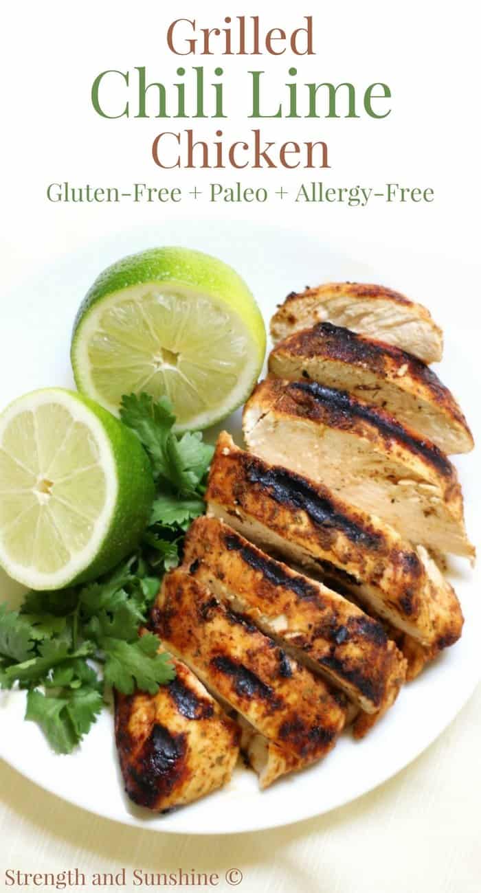 Grilled Chili Lime Chicken on a white plate with cilantro and a lime cut in half.
