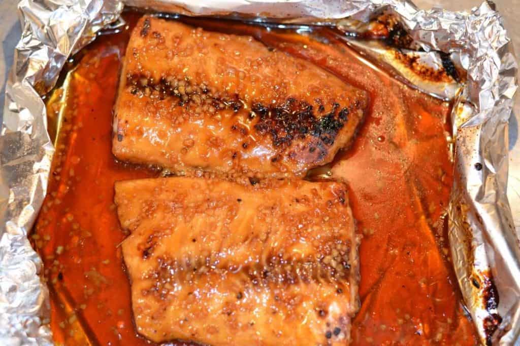 Honey Teriyaki salmon finished under broiler and ready to eat with foil peeled back