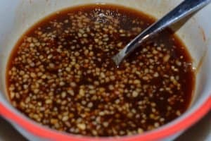 A bowl with honey teriyaki glaze mixed up and ready to pour
