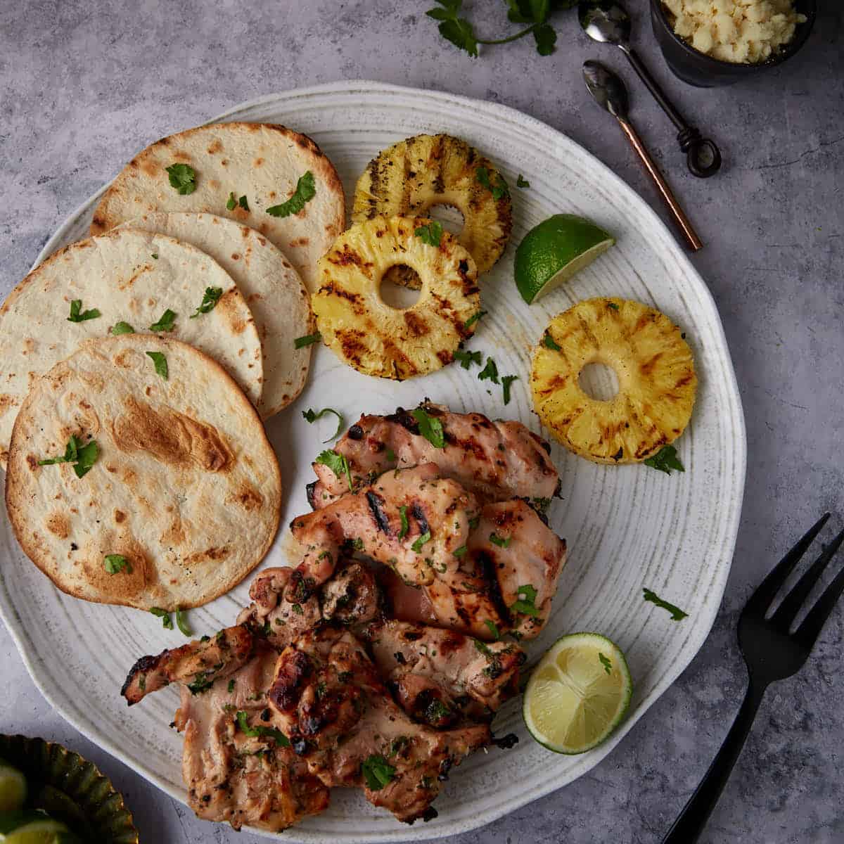Grilled Tequila Chicken Recipe (Chicken Marinade) on a platter with grilled tortillas and grilled pineapple.
