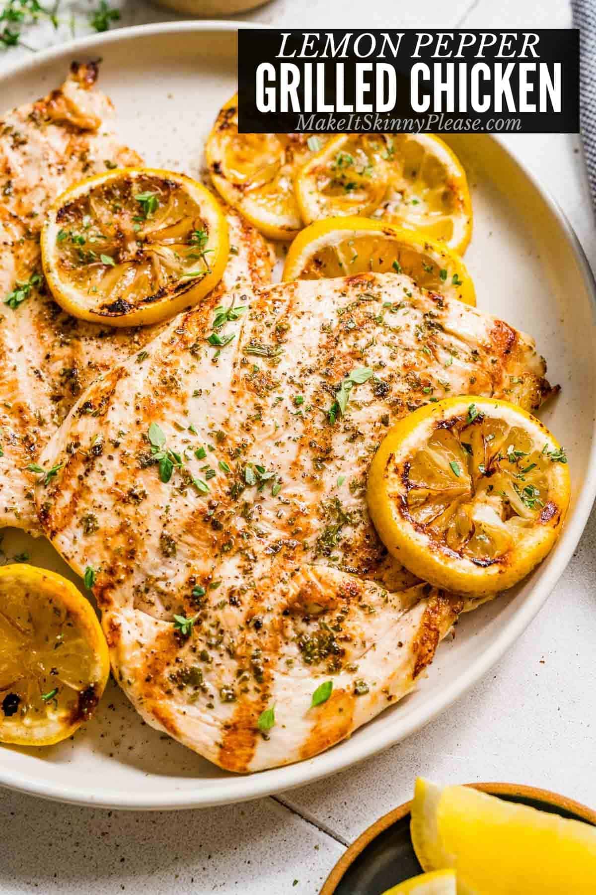 Grilled Lemon Pepper Chicken on a white platter with grilled pieces of lemon.