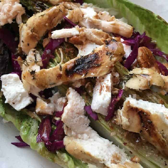 Grilled Romaine Salad with Chicken on top on a white platter