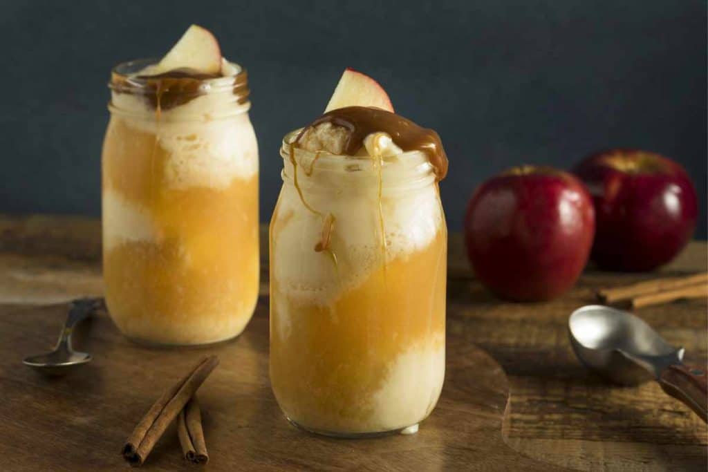 Caramel Apple Ice Cream Floats with caramel drizzled over the top of the mason jars that hold the float
