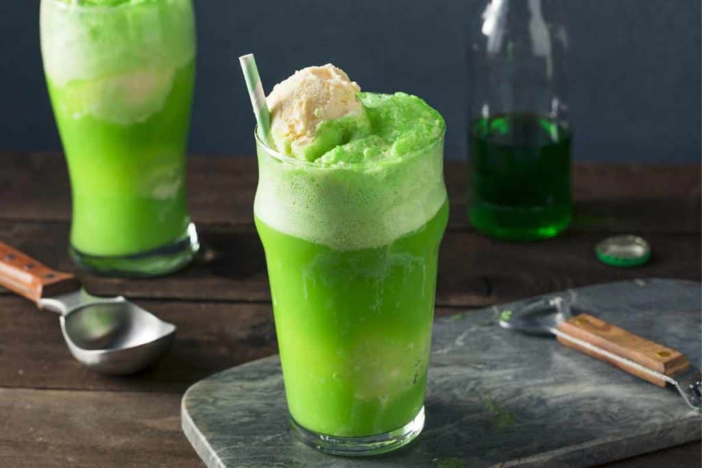 Lime soda ice cream float with vanilla ice cream in a tall glass with a straw