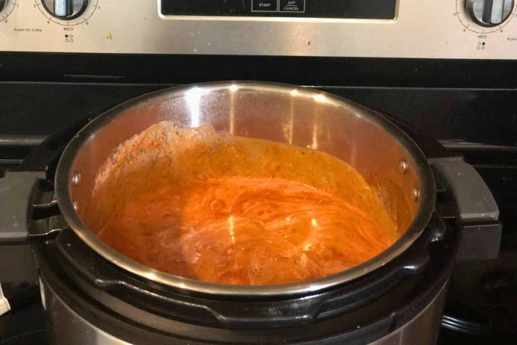 3-Jar Slow-Cooker Creamy Tomato Chicken ingredients mixed together in the crock pot and ready to cook on low.