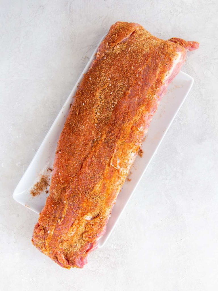 Rack of baby back ribs raw and rubbed with dry spice rub