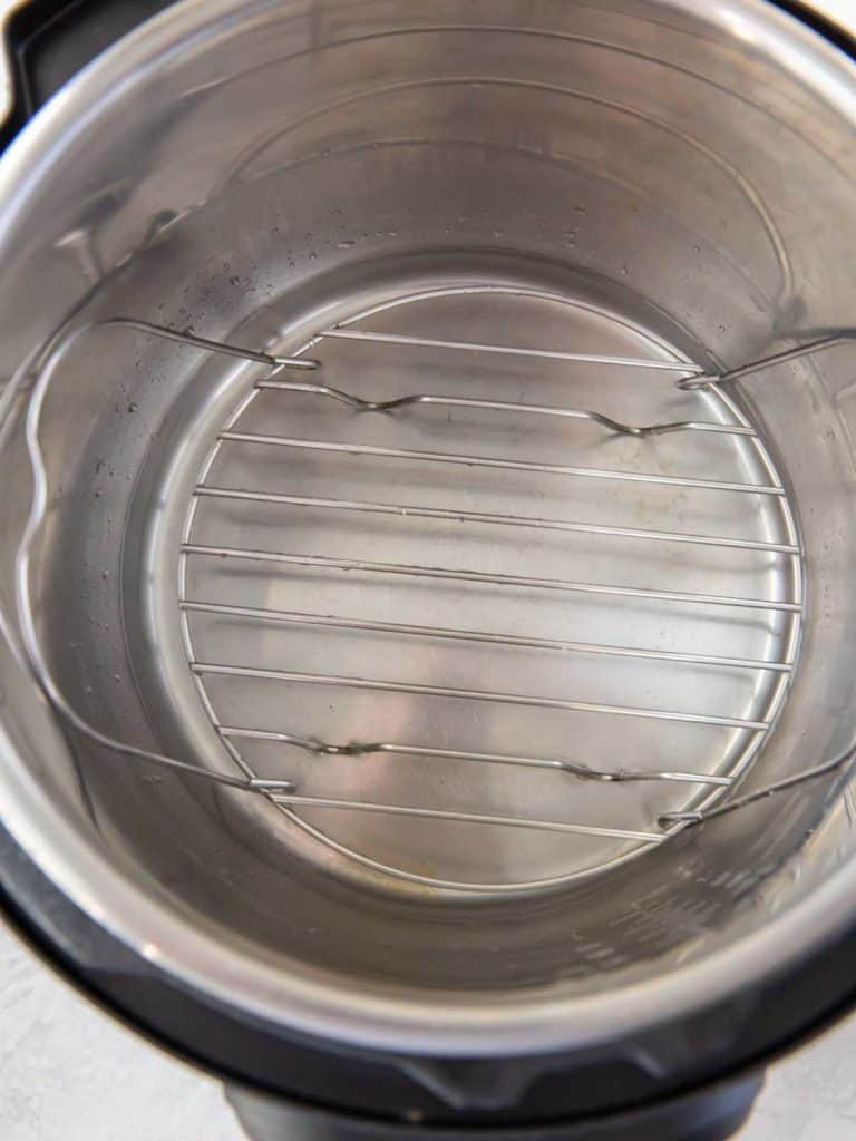 Trivet in the bottom of an instant pot to hold meat up off the bottom of the pot while cooking