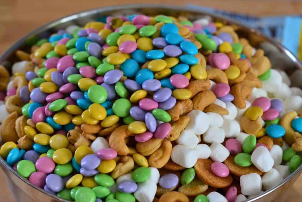 Milk chocolate m&m's being added to the Easter Bunny Snack Mix recipe