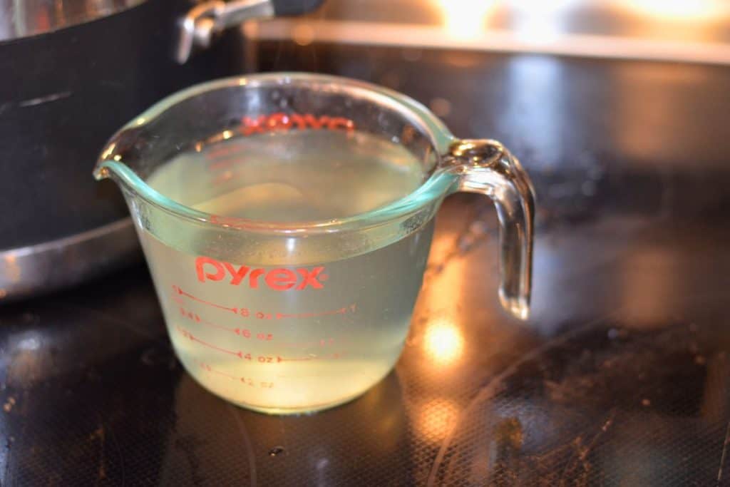 A glass measuring cup full of the reserved pasta cooking water
