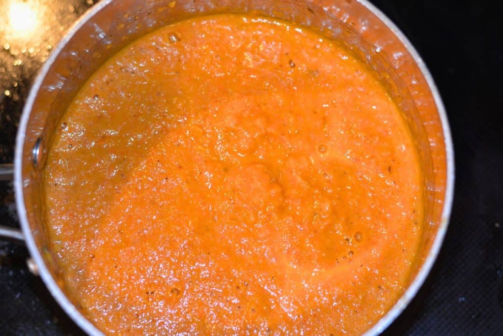 Above shot of the now smooth roasted cherry tomato sauce in a sauce pan