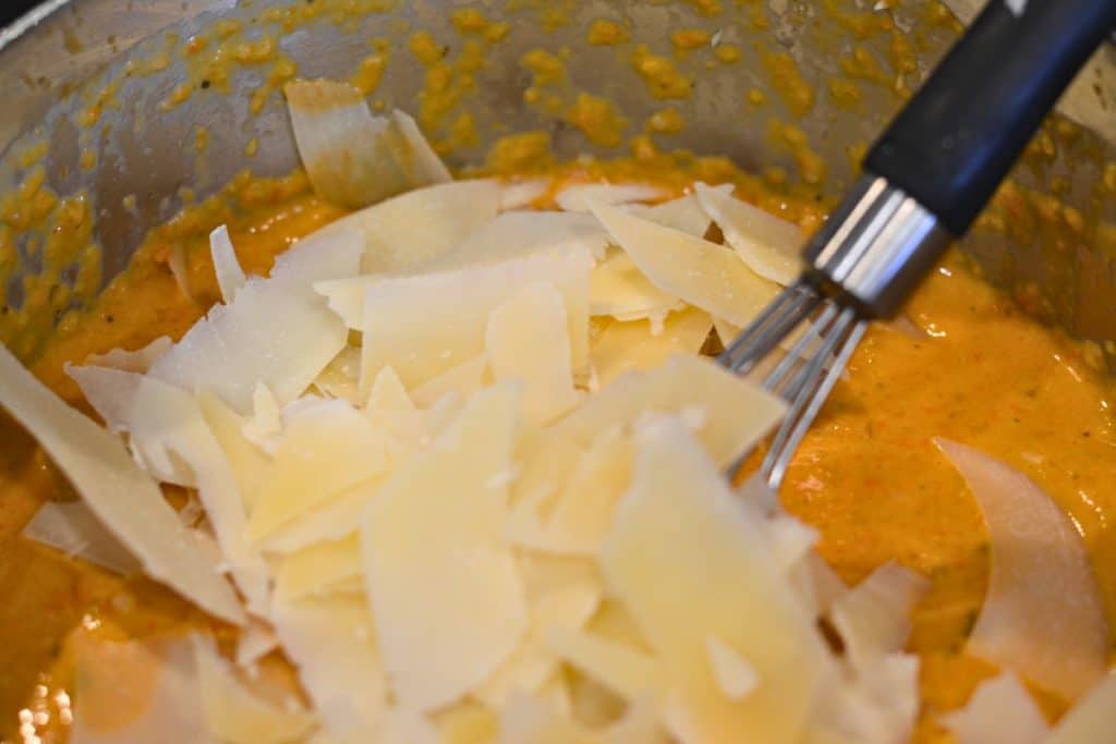 Adding in saved parmesan cheese to the blended sauce