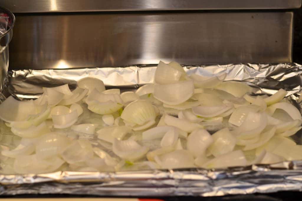 Chopped onions on a foil lined baking sheet