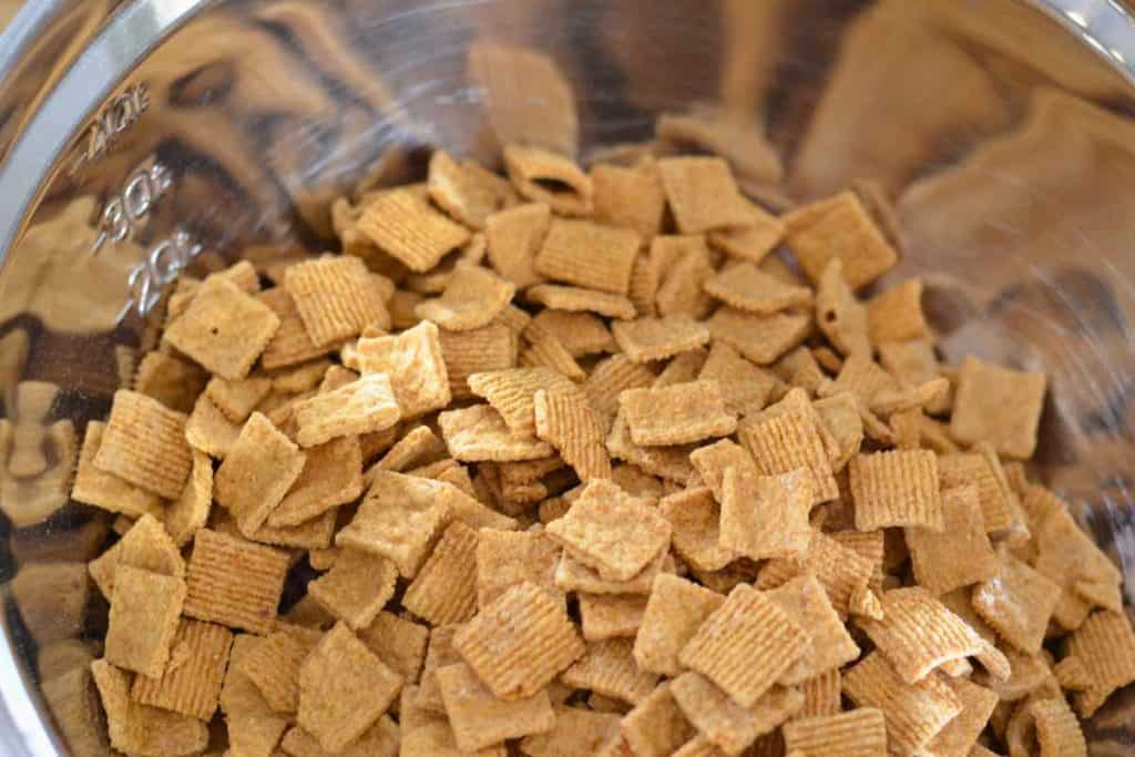 Graham Cracker cereal being added to the Easter Bunny Snack Mix recipe