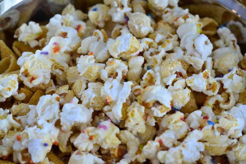 Popcorn being added to the Easter Bunny Snack Mix recipe