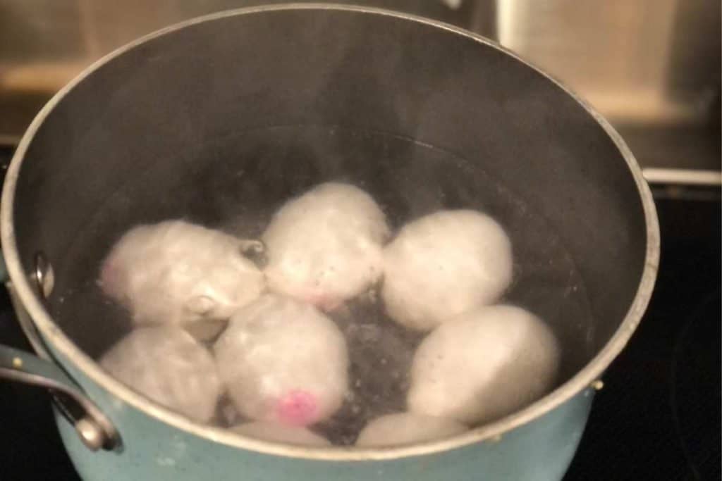Pot of eggs boiling for hard boiled eggs to make deviled eggs