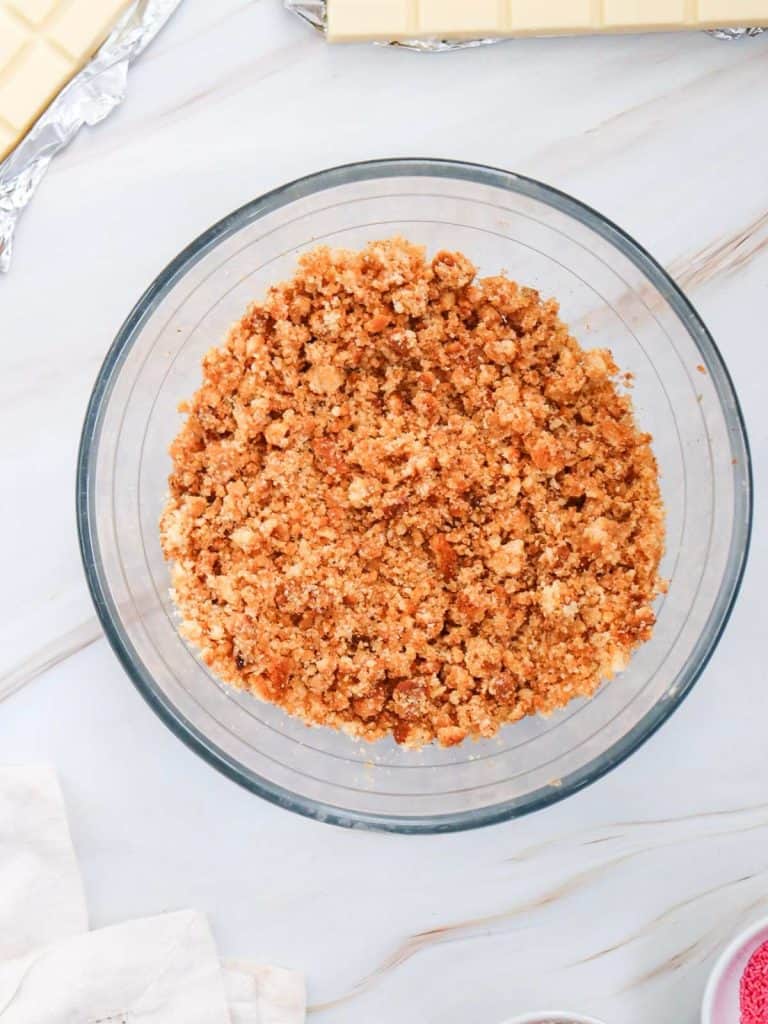 A bowl of cake crumbs all crushed up and ready for the next step of the cake pop recipe.