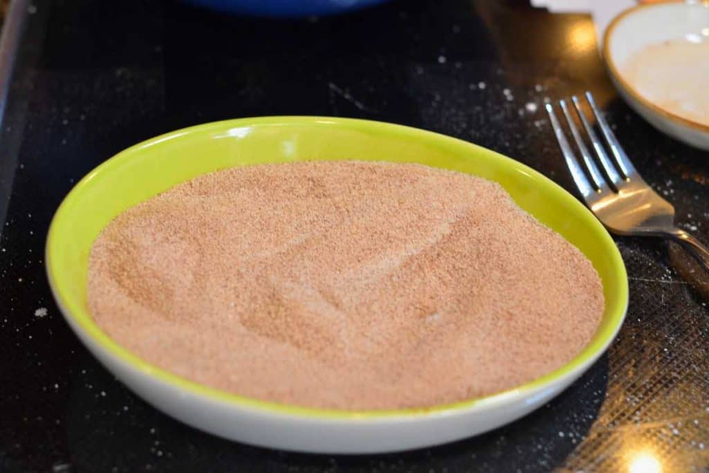 A small bowl with cinnamon and sugar mixed well together for the snickerdoodle cookie recipe.