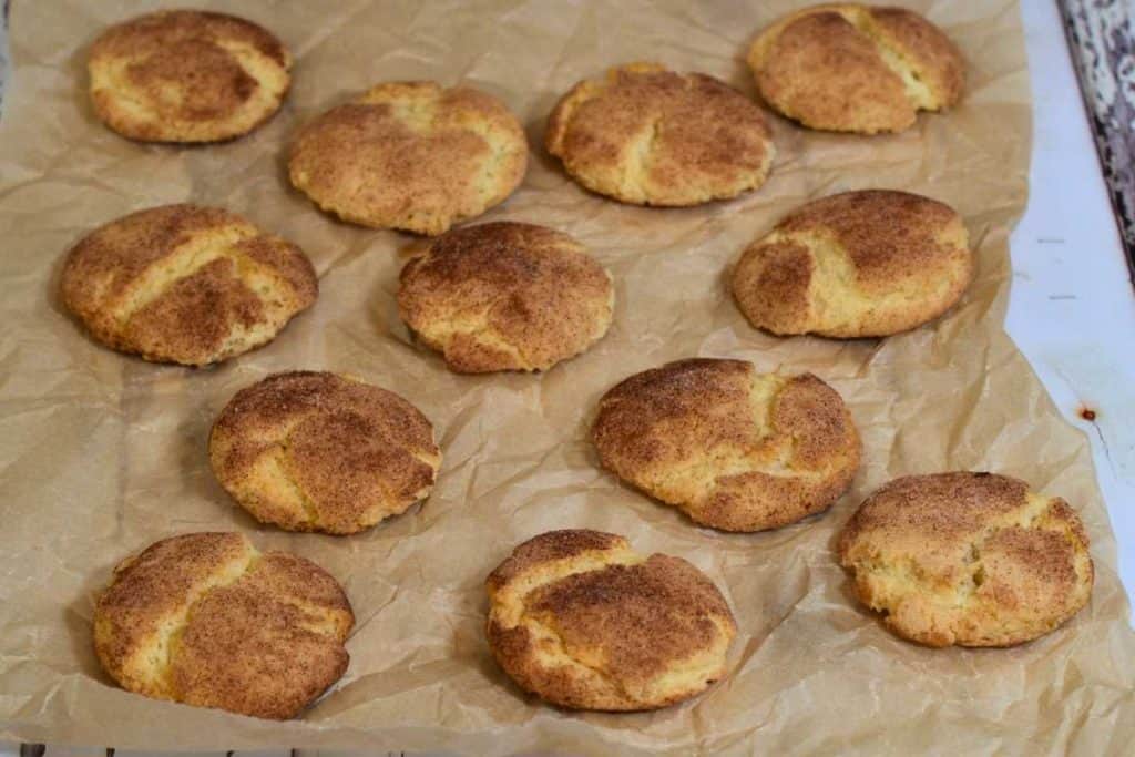 Snickerdoodle cookies sitting on crinkled parchment paper.