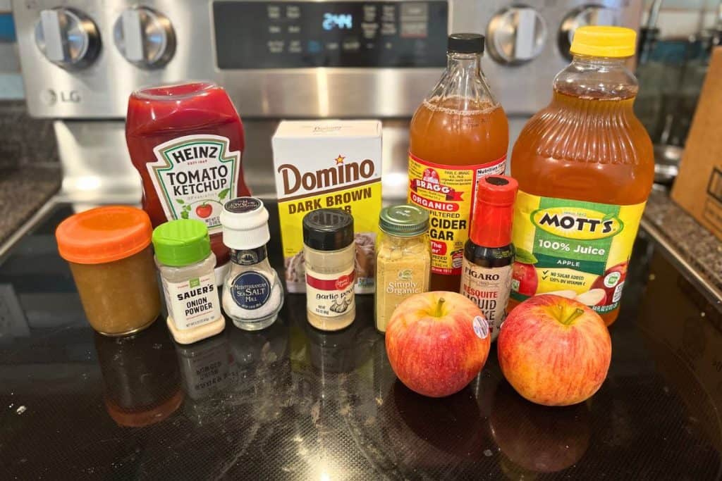 Ingredients for Sweet & Smoky Apple BBQ Sauce including apples, applesauce, ketchup, onion powder, sea salt, garlic powder, dark brown sugar, garlic powder, ginger, apple cider vinegar, liquid smoke and apple juice.