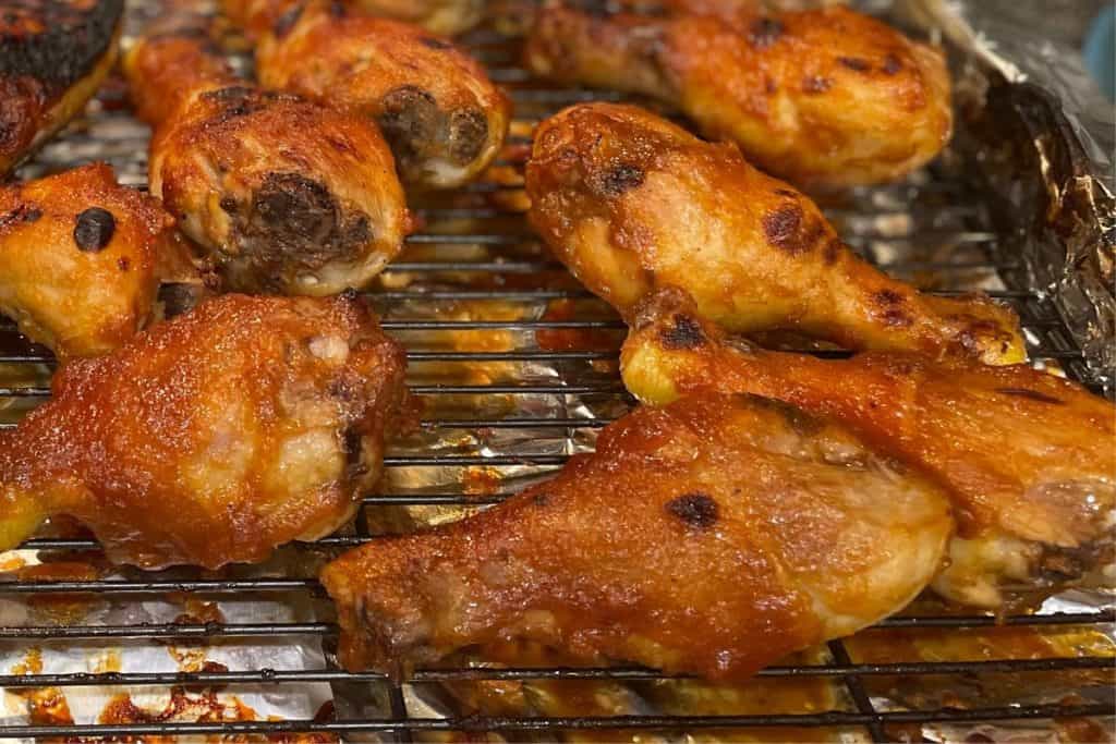 Close up of the BBQ Chicken Drumsticks that just came out of the broiler that are perfectly roasted and have nice sticky sauce.