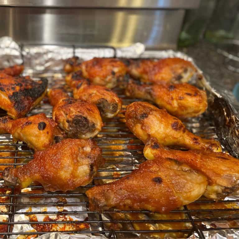 BBQ Chicken Drumsticks finished and out of the broiler with gorgeous browned cooking spots with a caramelized bbq sauce on them.