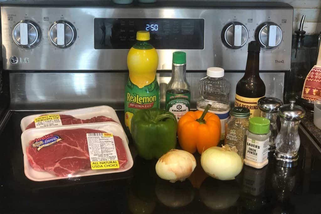 Ingredients for Mediterranean Beef Kebabs including steaks, onions, bell peppers, lemon juice, soy sauce, vegetable oil, worchestershire sauce, italian seasoning, onion powder, salt and pepper