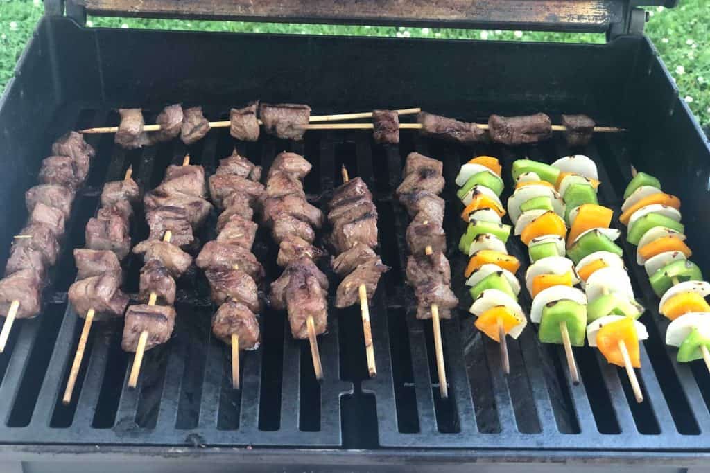 Both beef and vegetable kebabs on the grill cooking