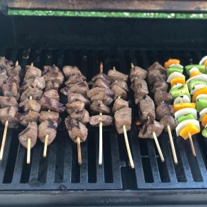 Beef and vegetable kebabs on the grill after they have been turned at least once