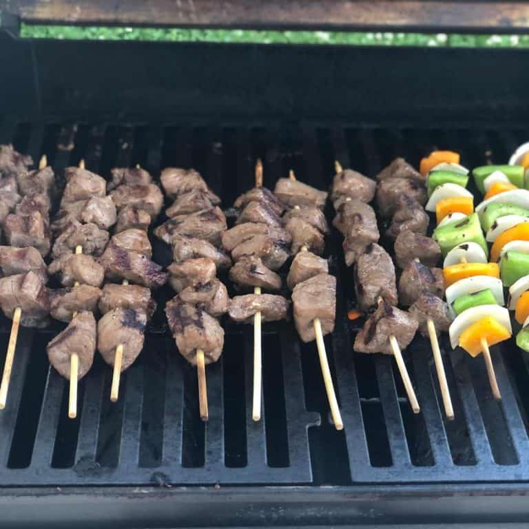 Beef and vegetable kebabs on the grill after they have been turned at least once