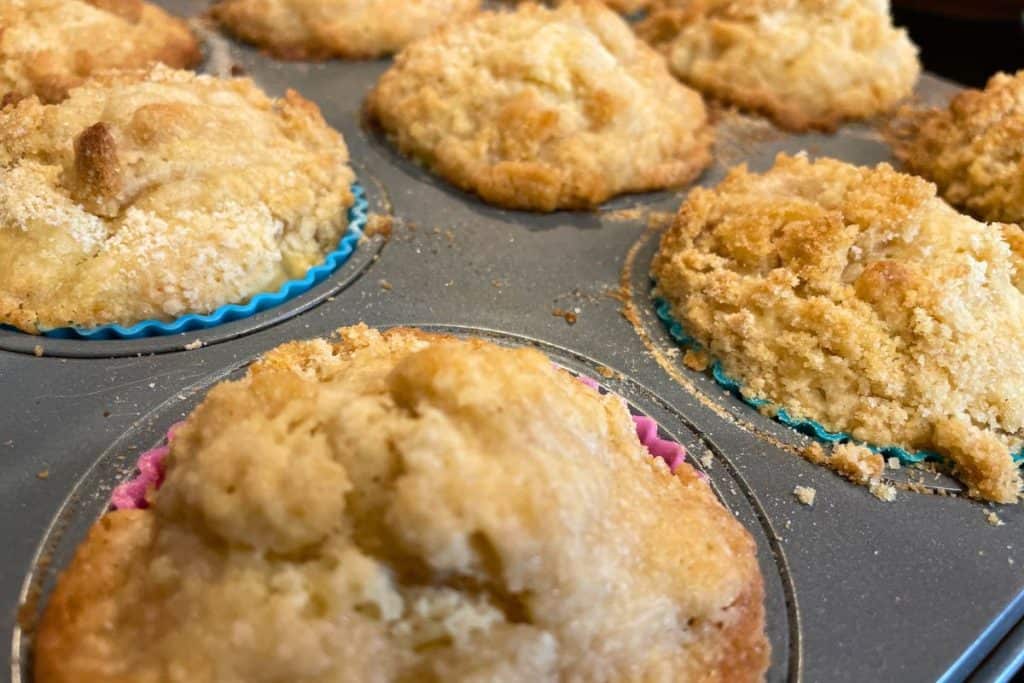 Apple cinnamon streusel crumble muffins fresh out of the oven and fully baked.